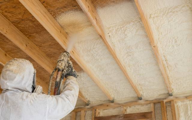Foam applied between the rafters and carried out over the top plate