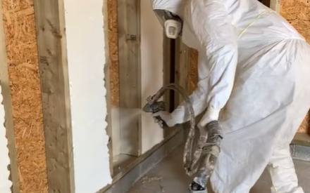 Closed cell foam rising in a stud bay against the sheathing